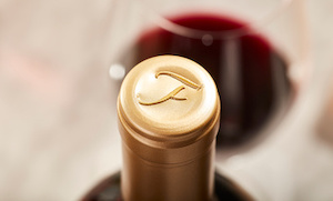 Close-up of Fortunati emblem on gold foil on a wine bottle