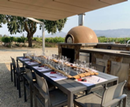 Tasting setup at Fortunati with pizza oven in the background